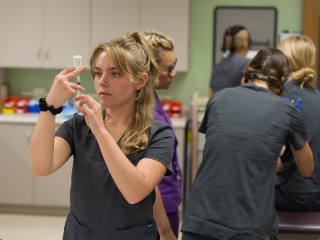 ACC Medical Assistant student filling syringe in class at the Littleton Campus.
