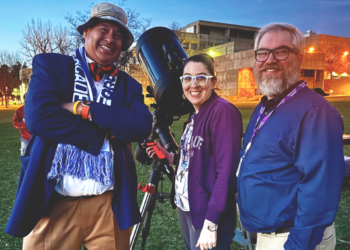 ACC astronomy faculty and instructors pose next to a telescope on the West Lawn of the Littleton Campus during a Star Party event.