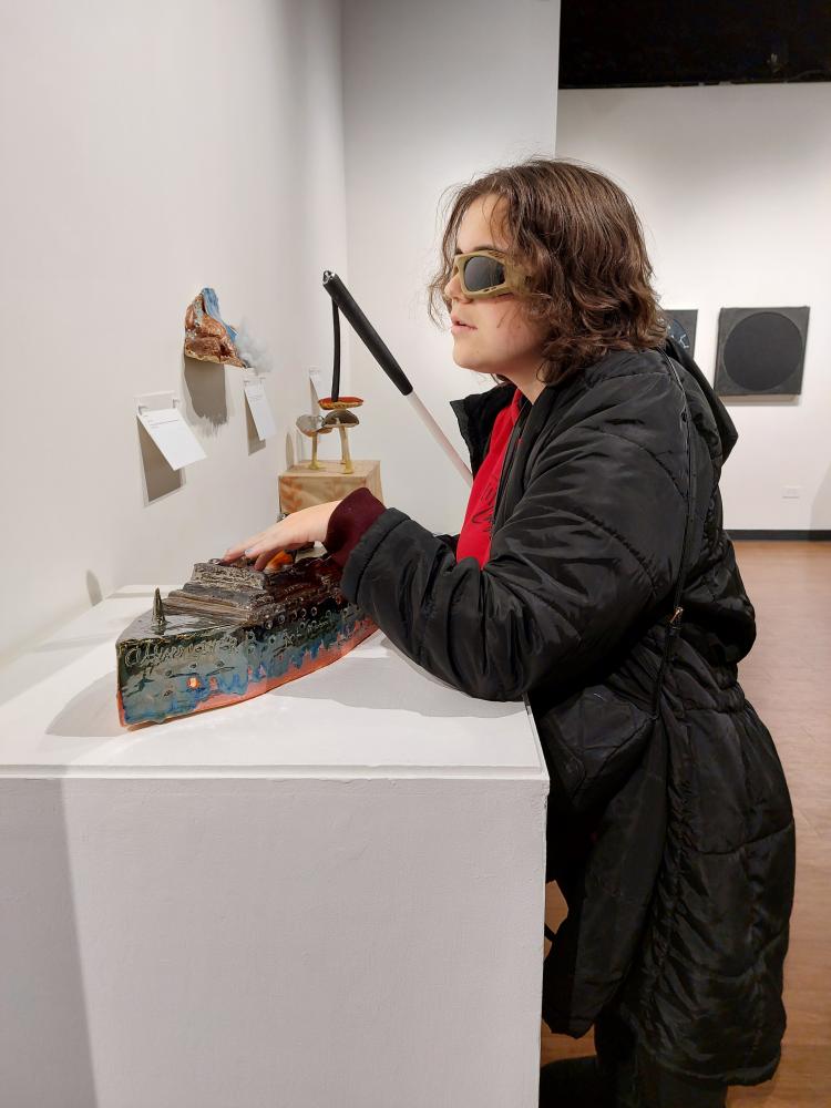 A student from the Colorado Center for the Blind enjoys the Shared Visions exhibition at Colorado Gallery of the Arts at ACC's Littleton Campus.