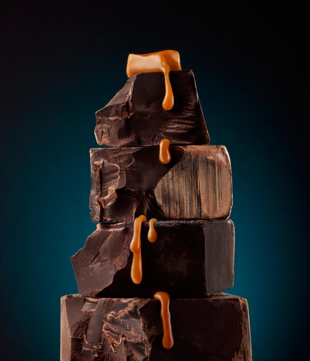 photo of chocolate blocks stacked with caramel running down them by Kate Blakeman