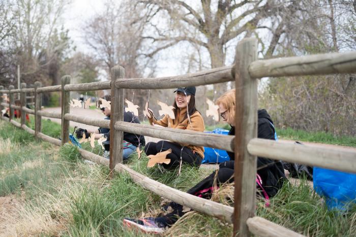 ACC students hanging birds from fence rails on the High Line Canal Trail