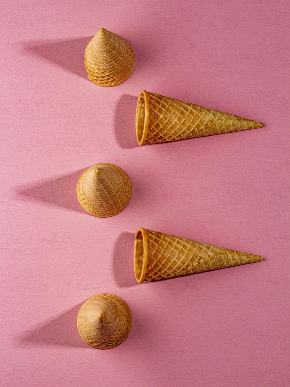 Photo of ice cream sugar cones on pink background - photo by Mercedes Gania