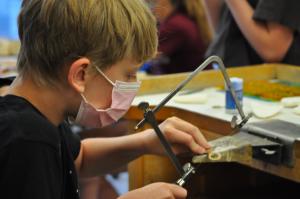 Student performing metal work during ACC's Summer Youth Camp first session.