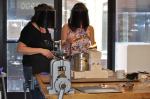 ACC students in Summer Youth Camp with metalworking gear and helmets.