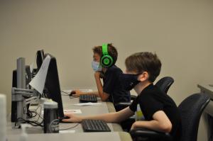 ACC Summer Youth Camp two students coding at computers at the Littleton Campus