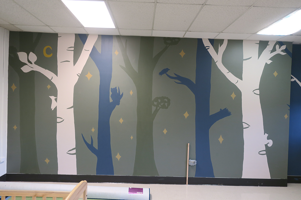 Mural of trees and animals painted by ACC's Studio Art Capstone class