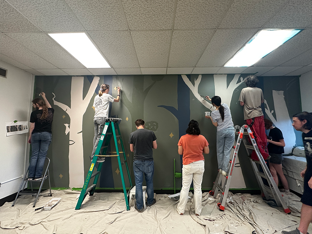 ACC Studio Art Capstone class painting a mural in ACC's Child Development Center