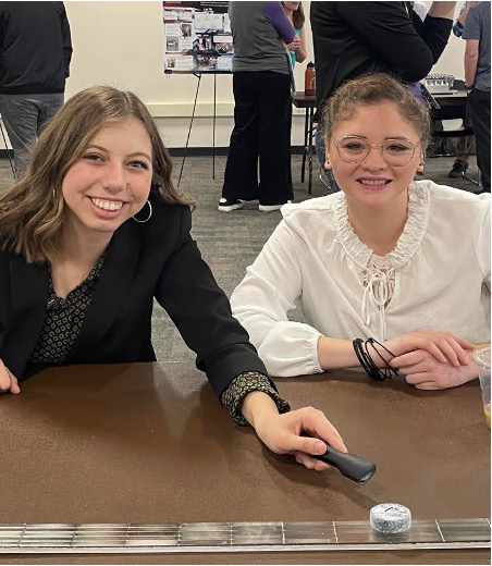 Pictured: Amanda Behmer and Carla Bolivar-Guerrero. Amanda and Carla presented the poster on Quantum Levitation of a High Temperature Superconducting YBa2Cu3O7 Magnet . 