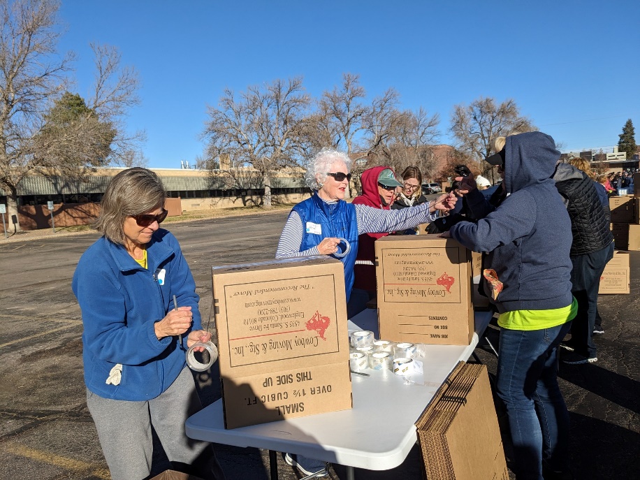 Diana Hornick and other volunteers putting boxes together.