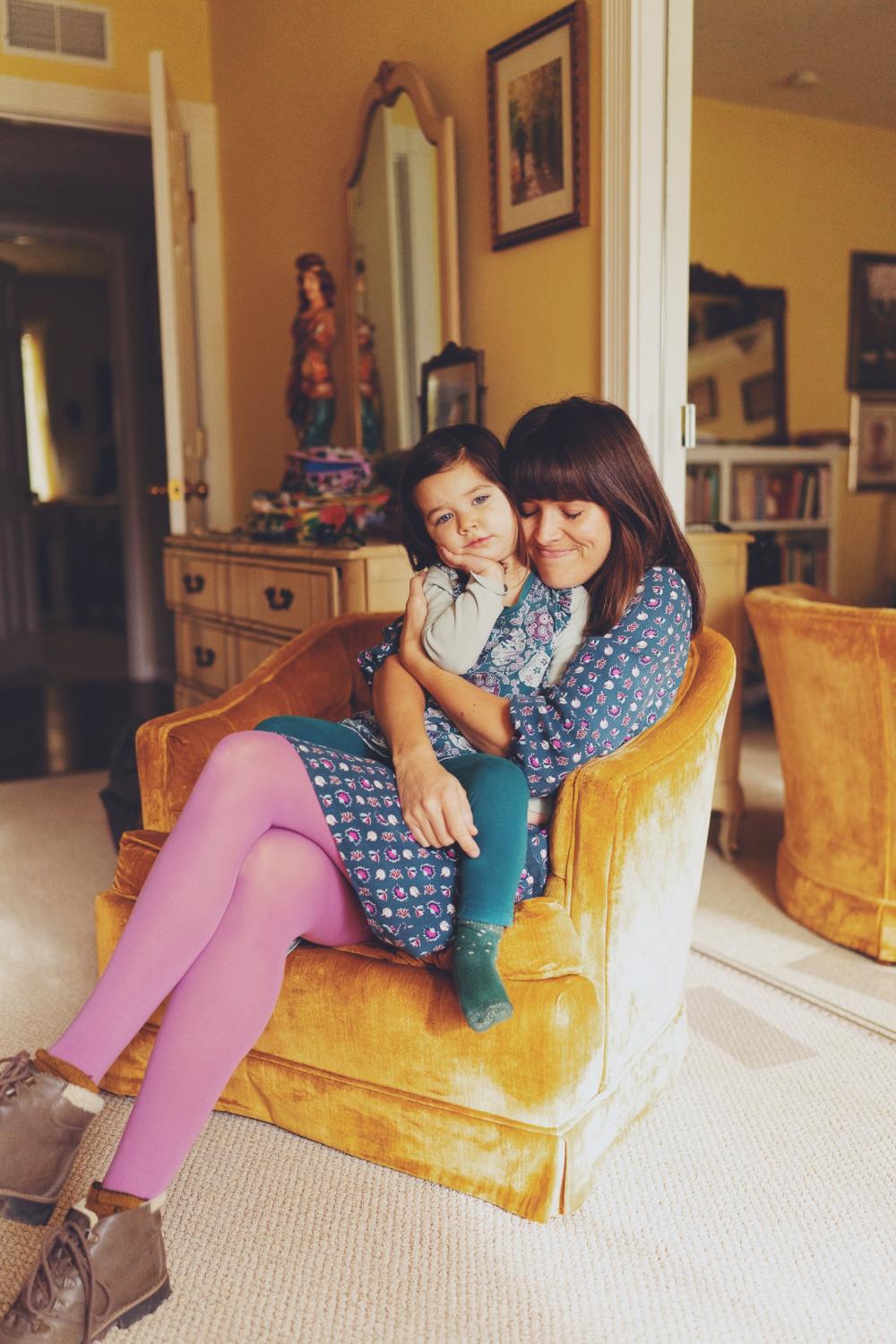 Portrait of mother and daughter hugging.