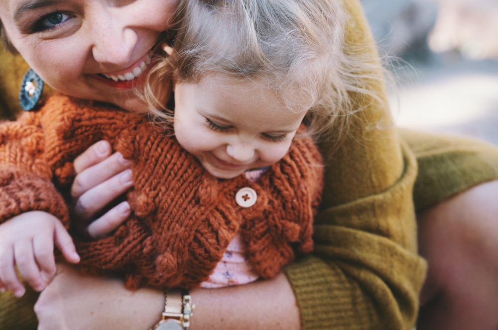 Portrait of mother and daughter hugging and smiling