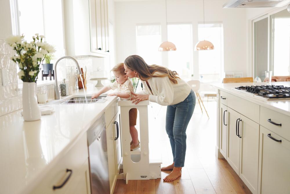 Portrait of mother helping son in the kitchen