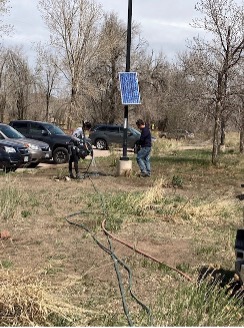 ACC volunteers seeding and watering grass, along with planting Apache Plume