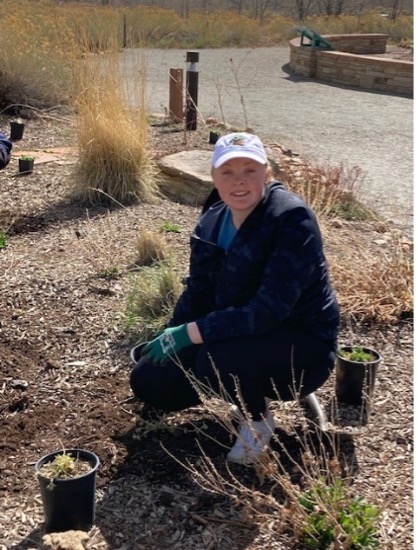 ACC faculty volunteer clearing weeds.