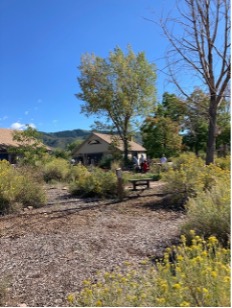 trail and building with mountains in the background