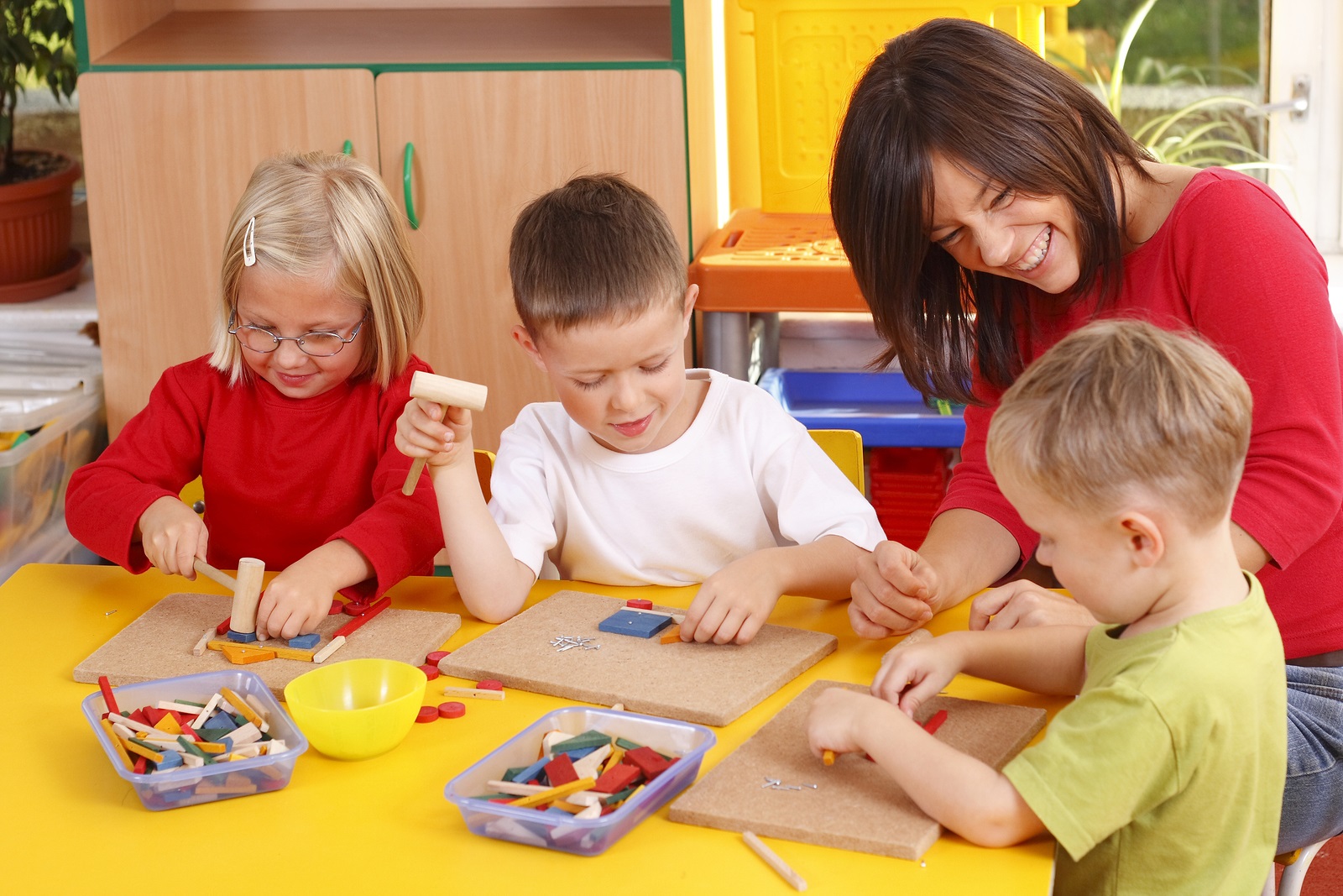 Teacher with students doing a craft