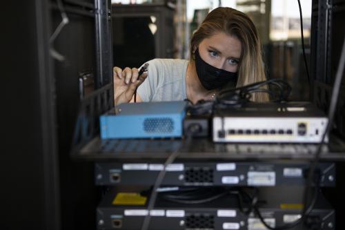 Kalyn (Cook) Cowdin, ACC Cybersecurity student working on servers at Sturm Collaboration Campus at Castle Rock