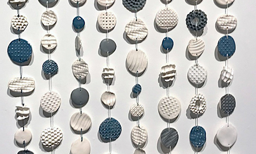 Adams Serenity - hanging pieces of stone on string