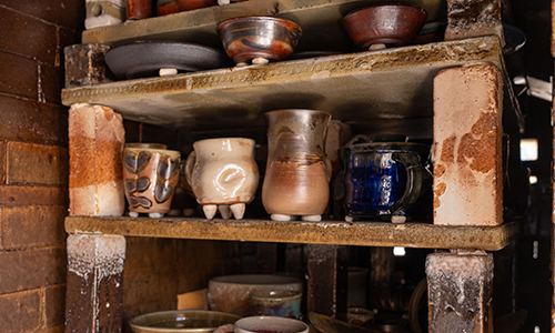 ACC kiln with various pieces of pottery on it