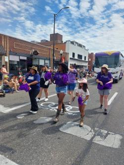 ACC Study Abroad students walking on Main Street in downtown Littleton during the Western Welcome Week parade.