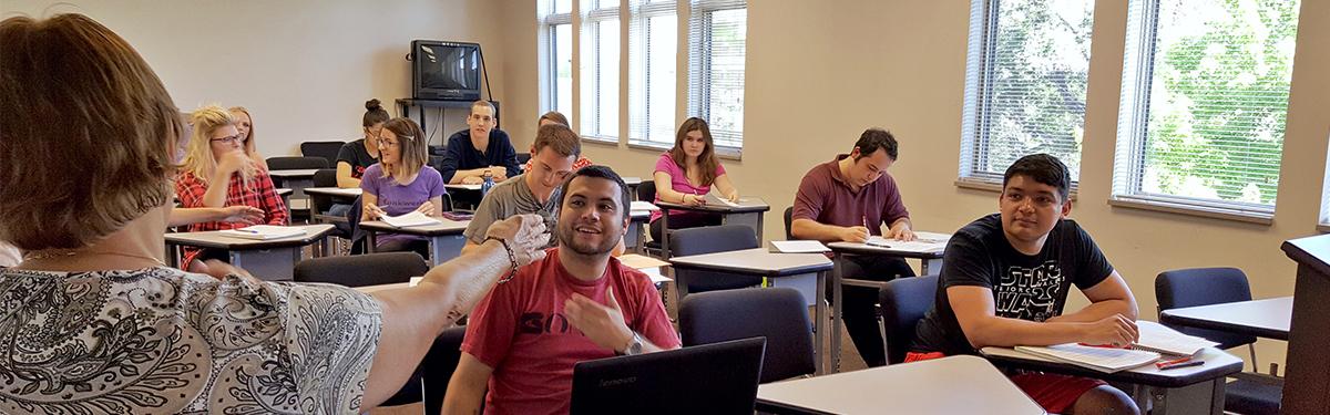 ACC students sitting at desks in a classroom at the Littleton Campus.