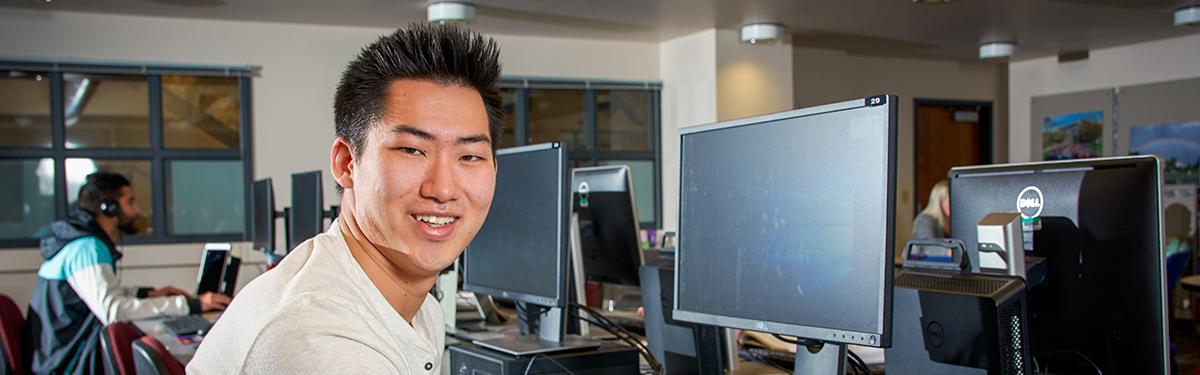 An Arapahoe Community College student working at the computer lab for their online degree program.