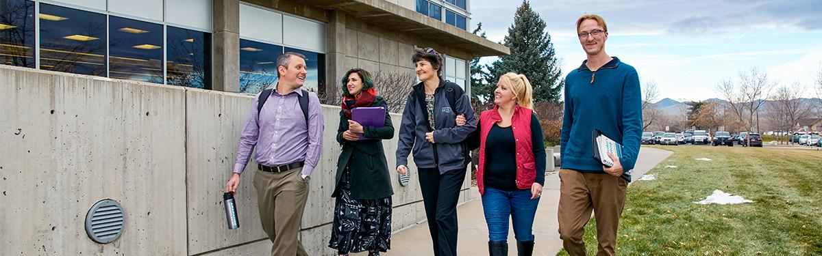 ACC students walking together in front of the main building at the Littleton Campus.
