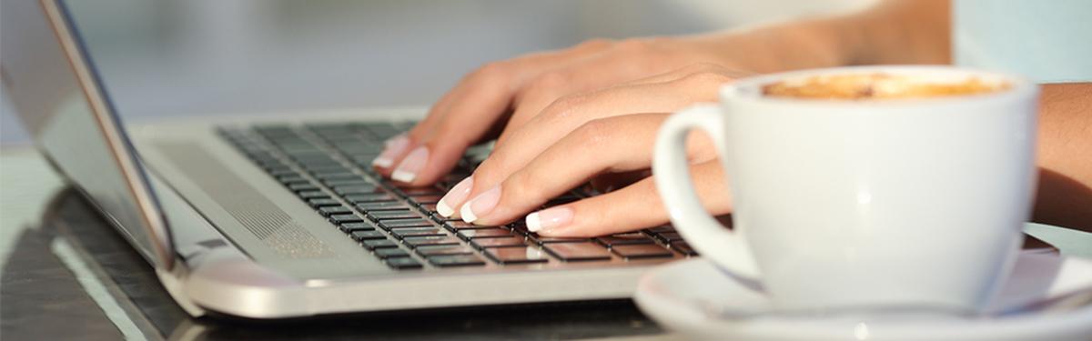 Student typing on laptop