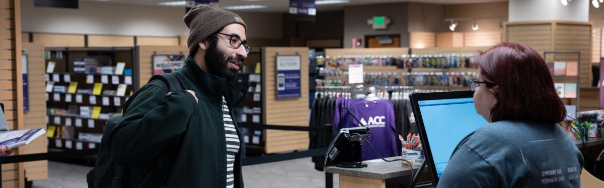 A student checking out at the ACC bookstore.