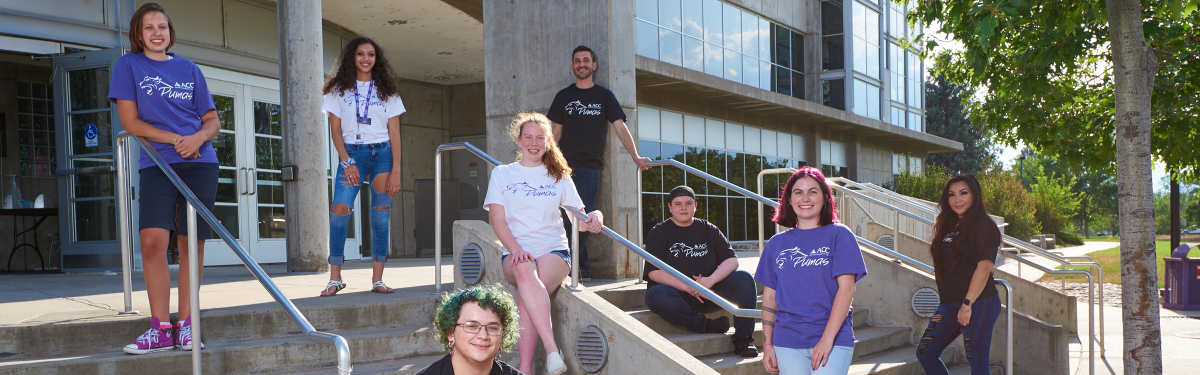 ACC students staggered on the stairs in front of the main entrance to the Littleton Campus Main Building.
