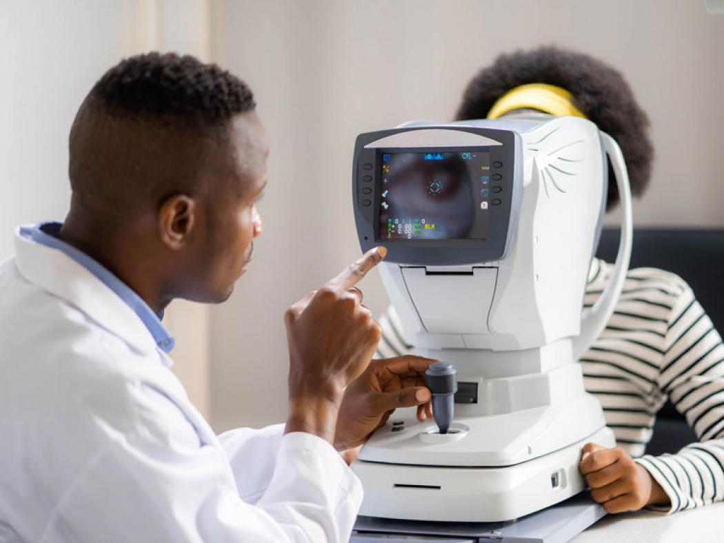 Ophthalmic Technician examining patient's eye.