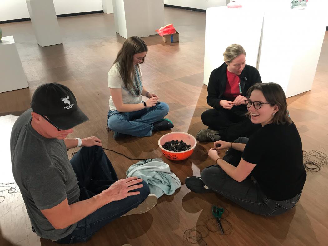 Students working with beads and twine at the Colorado Gallery of the Arts at ACC's Littleton Campus.