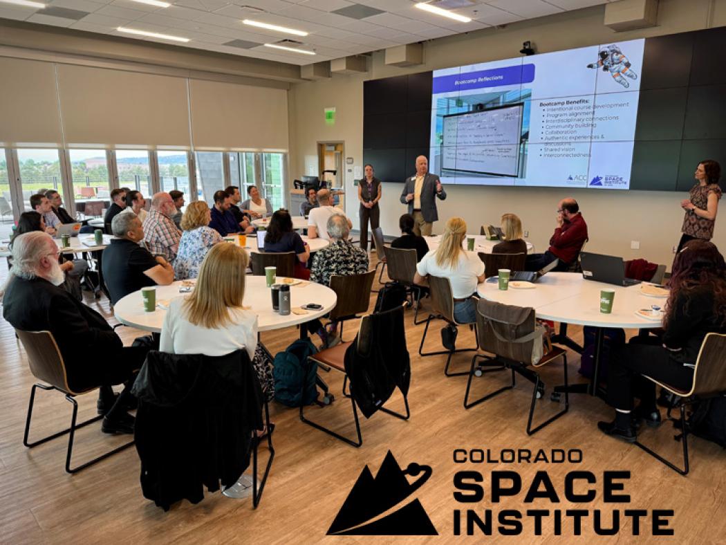 Participants at ACC's Space Educator Bootcamp sitting at tables and viewing presentation.