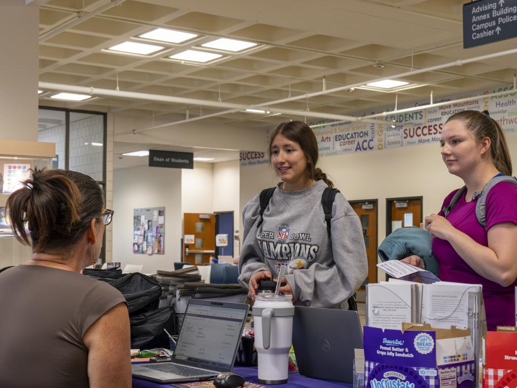 ACC students at a resource table in the student lounge at the Littleton Campus.