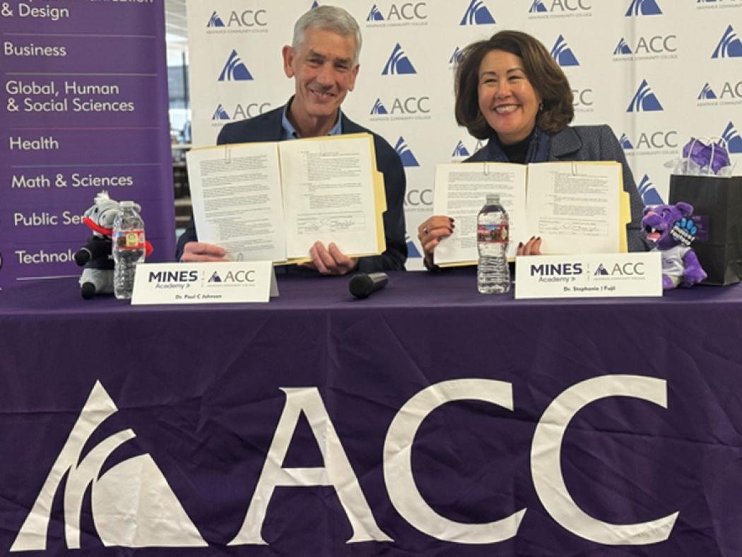 ACC President Stephanie J. Fujii and Colorado School of Mines President Paul C. Johnson signing partnership documents.