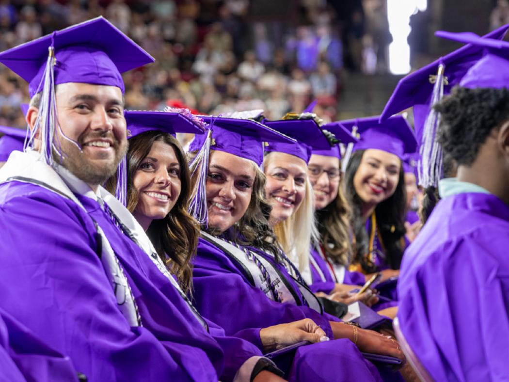 ACC graduates posing for photo at 2025 Commencement ceremony.