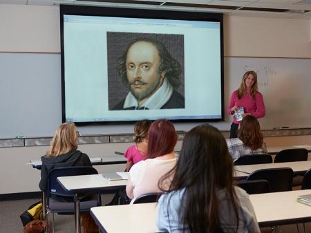 ACC faculty member teaching in front of classroom at the Littleton Campus.