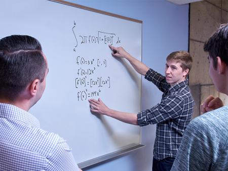 Arapahoe Community College Math students working at a white board in a classroom at the Littleton Campus.