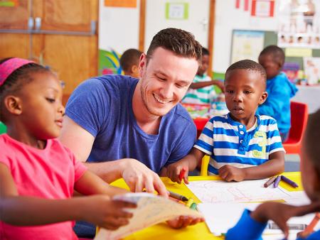 Teacher sitting with students