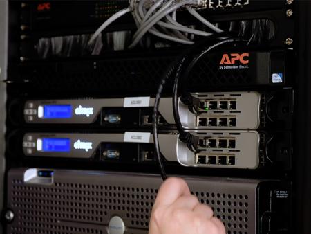 A student in the ACC cybersecurity program adjusting a server set-up.