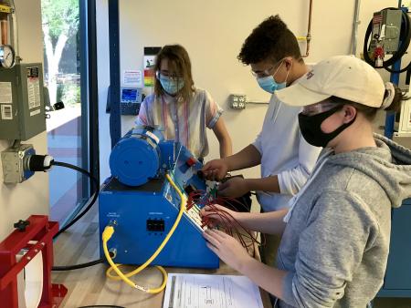 Arapahoe Community College Mechatronics students (Ana Poland, Demetrius Boyd and Claudia Podlesna) in lab at the Littleton Campus.