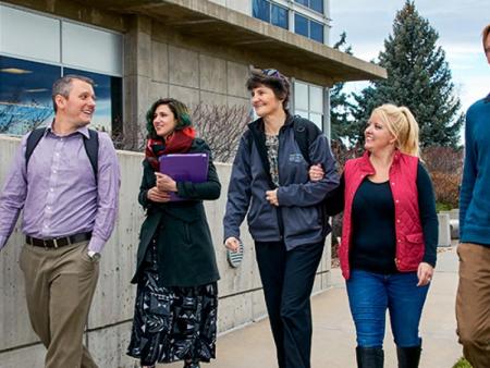 ACC students and staff walking in front of the main building on the Littleton Campus.