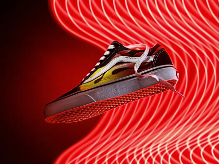 Tennis shoe flying through air (red background). Photo by Nicole Hartman, ACC photography student