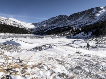 Woman hiking in snowy mountains. Photo by Samantha Henderson, ACC photography student