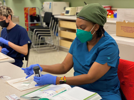 ACC student / medical assistant apprentice working in classroom at the Littleton Campus.