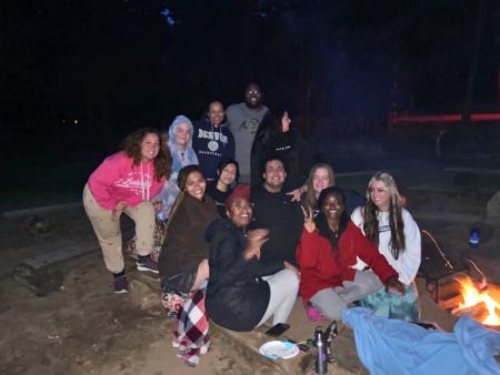 ACC TRIO SSS students around a campfire during a community building trip to Estes Park, CO.