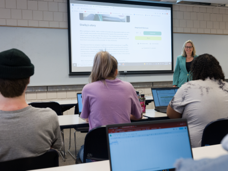 ACC economics class - students at computers while faculty member Tami Bertelsen leads the class.