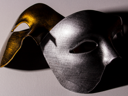 photo of 2 masks, 1 gold and 1 silver, by Anthony Snyder