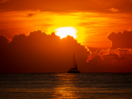 photo of a Boat on the water at sunset by Anthony Snyder