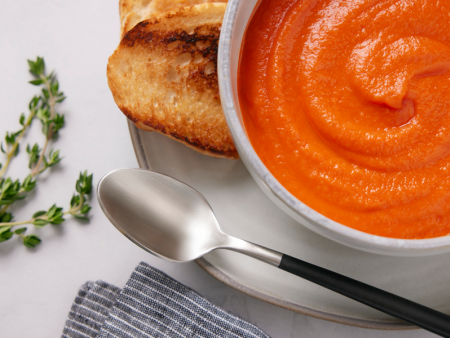 Photo of tomato soup in a bowl with spoon by Kate Blakeman